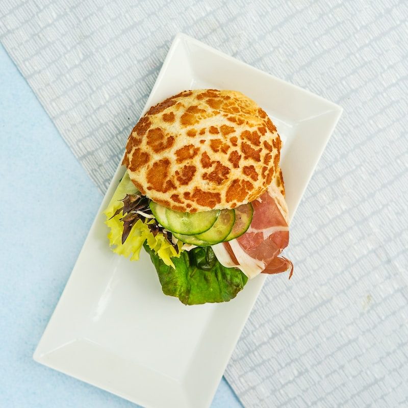Tiger bread roll filled with proscuitto and salad